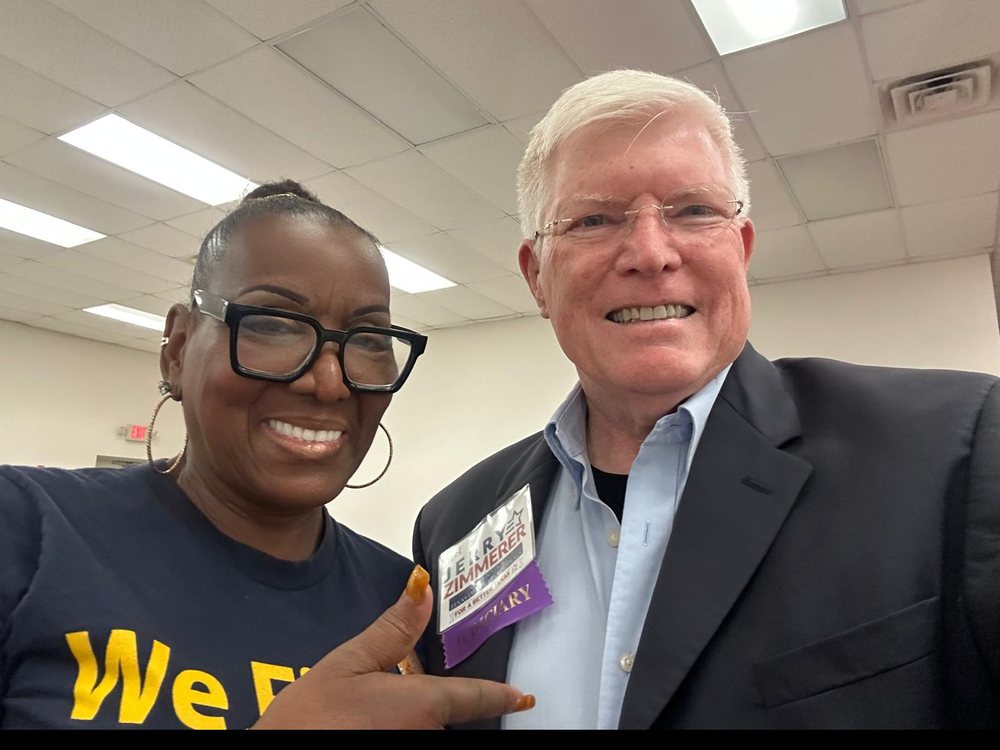 Jerry Zimmerer with a union member pointing at his campaign badge